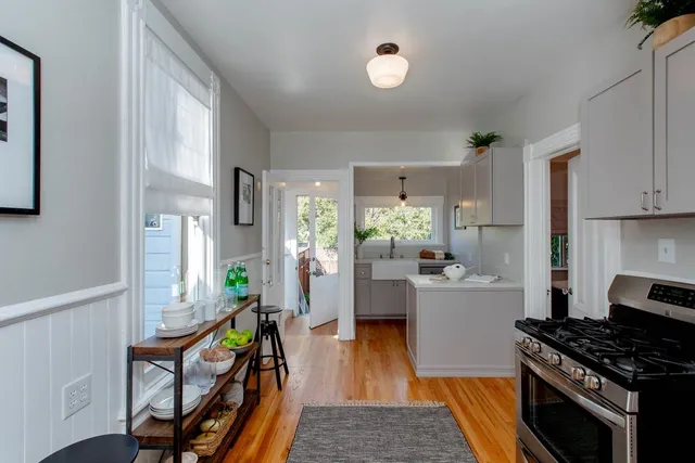 a living room with furniture a flat screen tv and a window