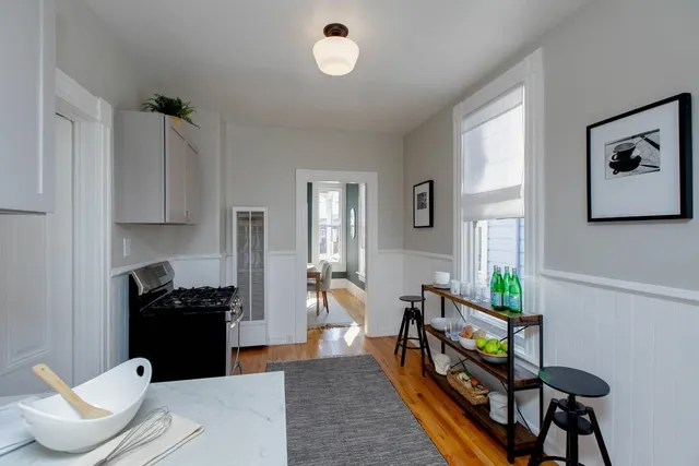 a kitchen with stainless steel appliances granite countertop a refrigerator and a stove top oven