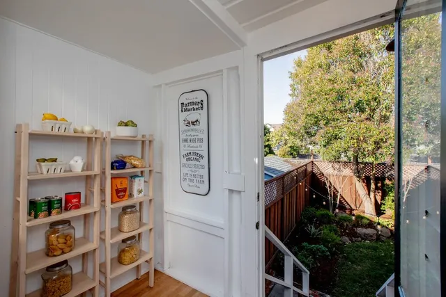a view of a hallway with workspace and a window