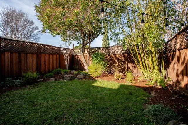 a view of a patio with a table chairs and a fire pit