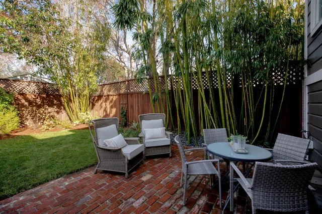 a view of a patio with table and chairs and wooden floor