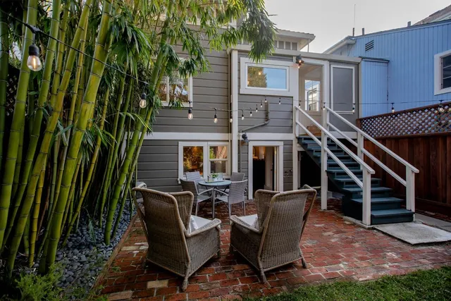 a living room with furniture and a lamp