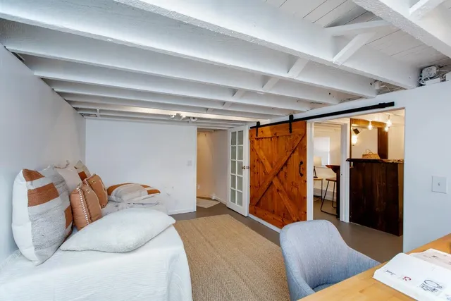 a bedroom with furniture and a window