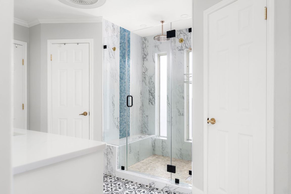 10218 Braemar Drive Austin, TX 78747 - Photo 18 of 34 Bathroom featuring a marble finish shower and ornamental molding