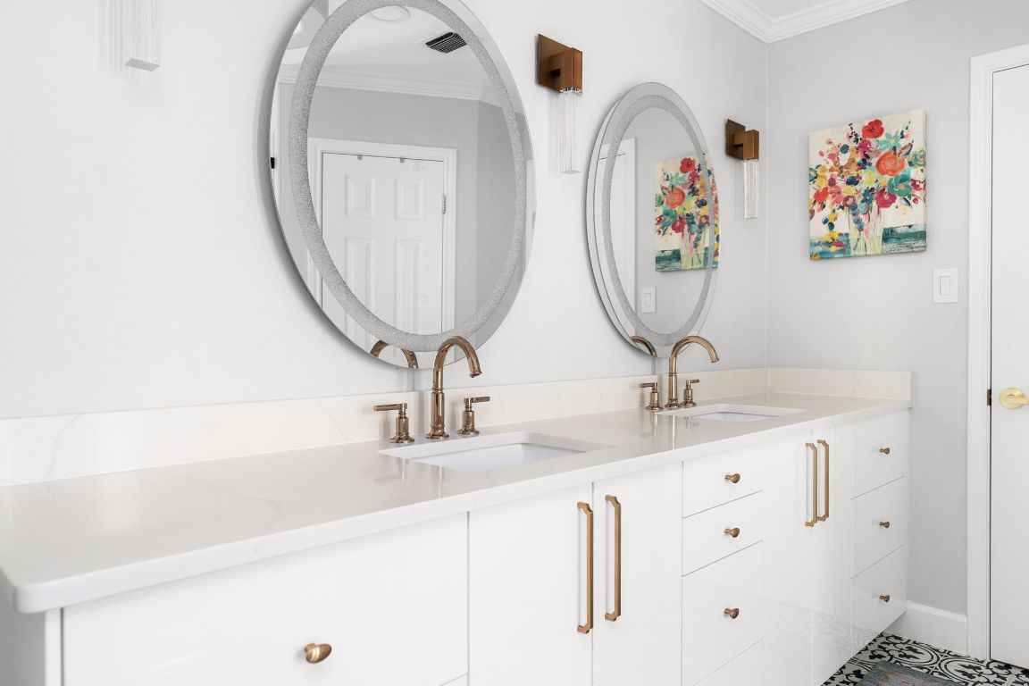 10218 Braemar Drive Austin, TX 78747 - Photo 20 of 34 Bathroom featuring double vanity and ornamental molding