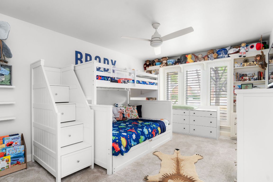 10218 Braemar Drive Austin, TX 78747 - Photo 26 of 34 Bedroom with light colored carpet and a ceiling fan
