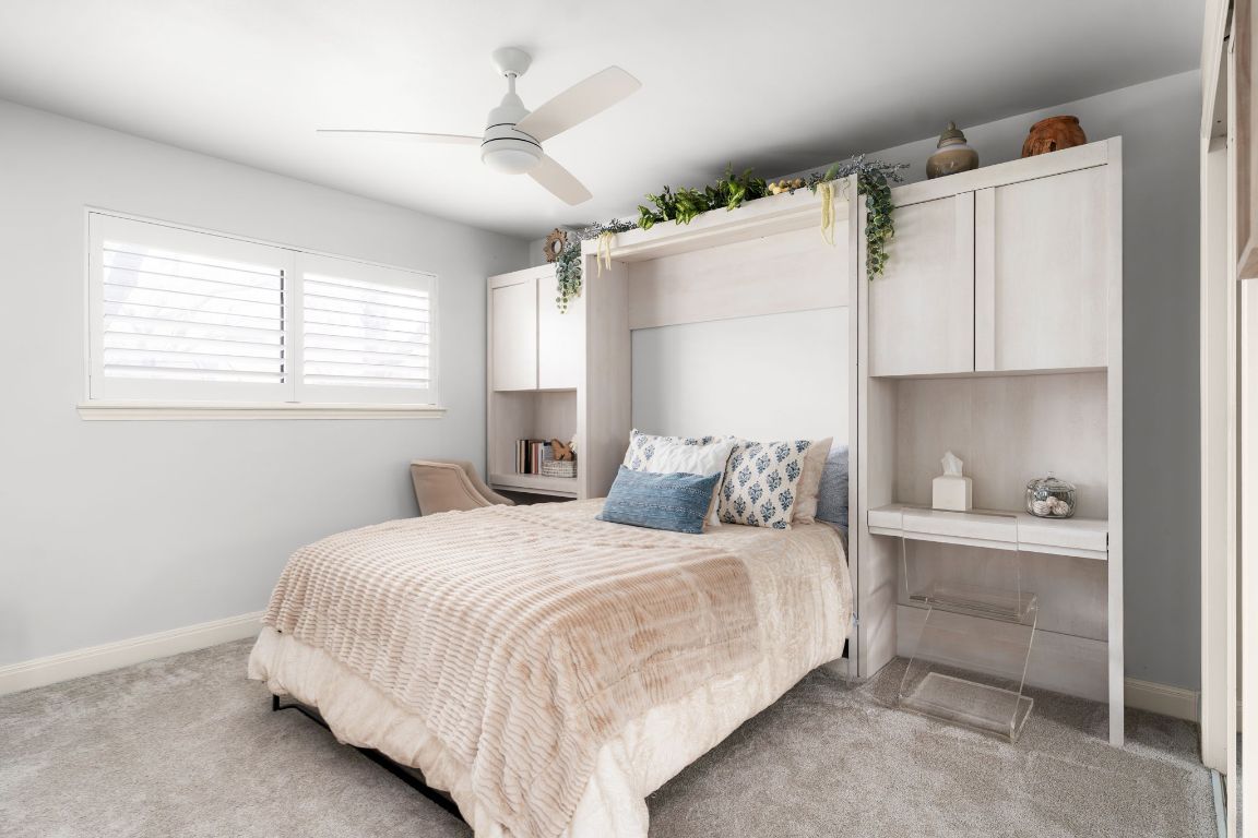 10218 Braemar Drive Austin, TX 78747 - Photo 27 of 34 Bedroom with light colored carpet and a ceiling fan