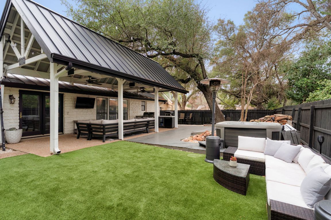 10218 Braemar Drive Austin, TX 78747 - Photo 29 of 34 Fenced backyard featuring an outdoor hangout area, ceiling fan, an outdoor kitchen, and a patio area