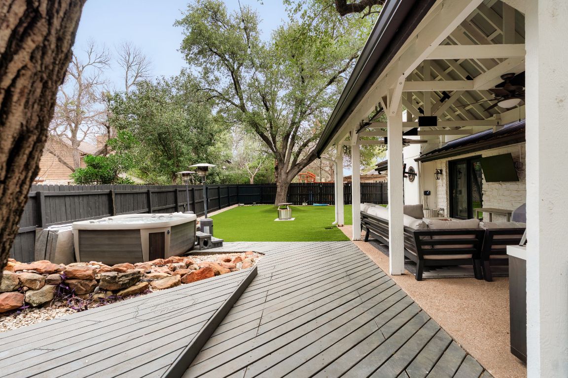 10218 Braemar Drive Austin, TX 78747 - Photo 32 of 34 Deck featuring a fenced backyard, an outdoor living space, a patio, and a hot tub