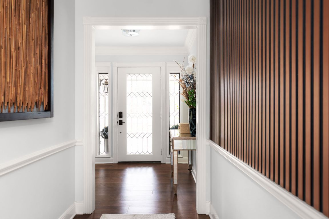 10218 Braemar Drive Austin, TX 78747 - Photo 5 of 34 Entrance foyer with dark wood-style flooring and ornamental molding