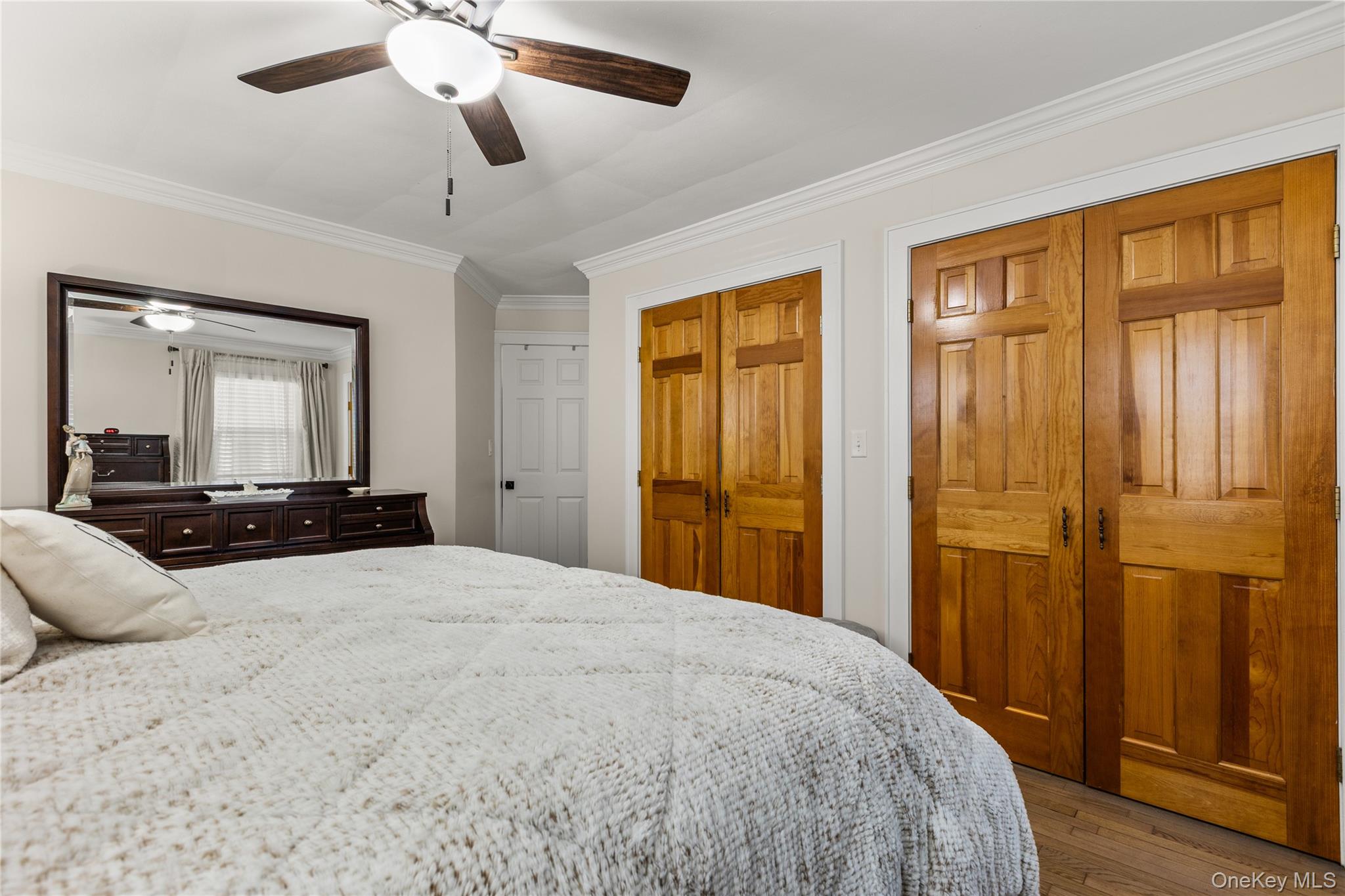 26 Community Road Bay Shore, NY 11706 - Photo 12 of 27 a large bedroom with a large bed and wooden floor