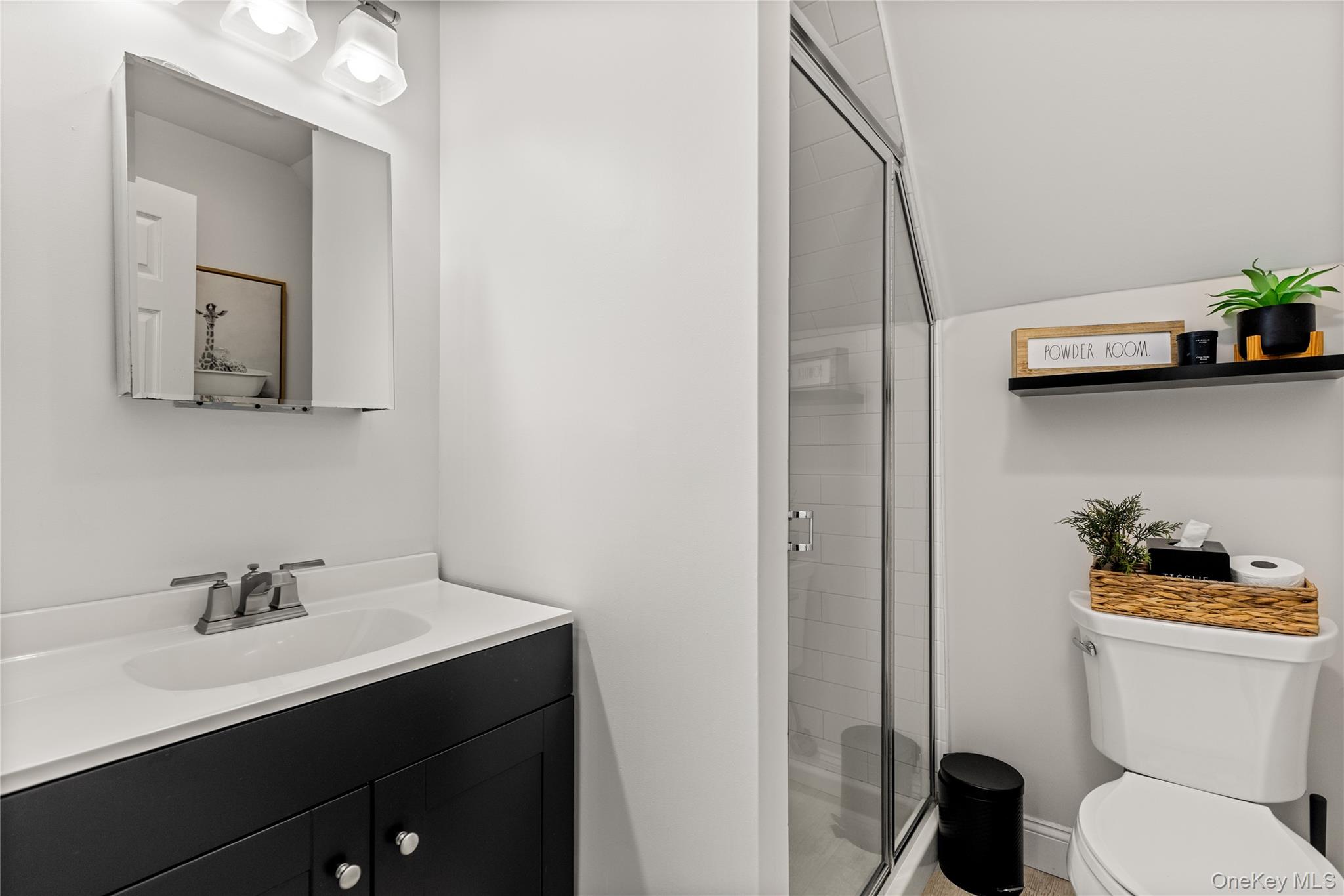 26 Community Road Bay Shore, NY 11706 - Photo 19 of 27 a bathroom with a toilet sink and mirror