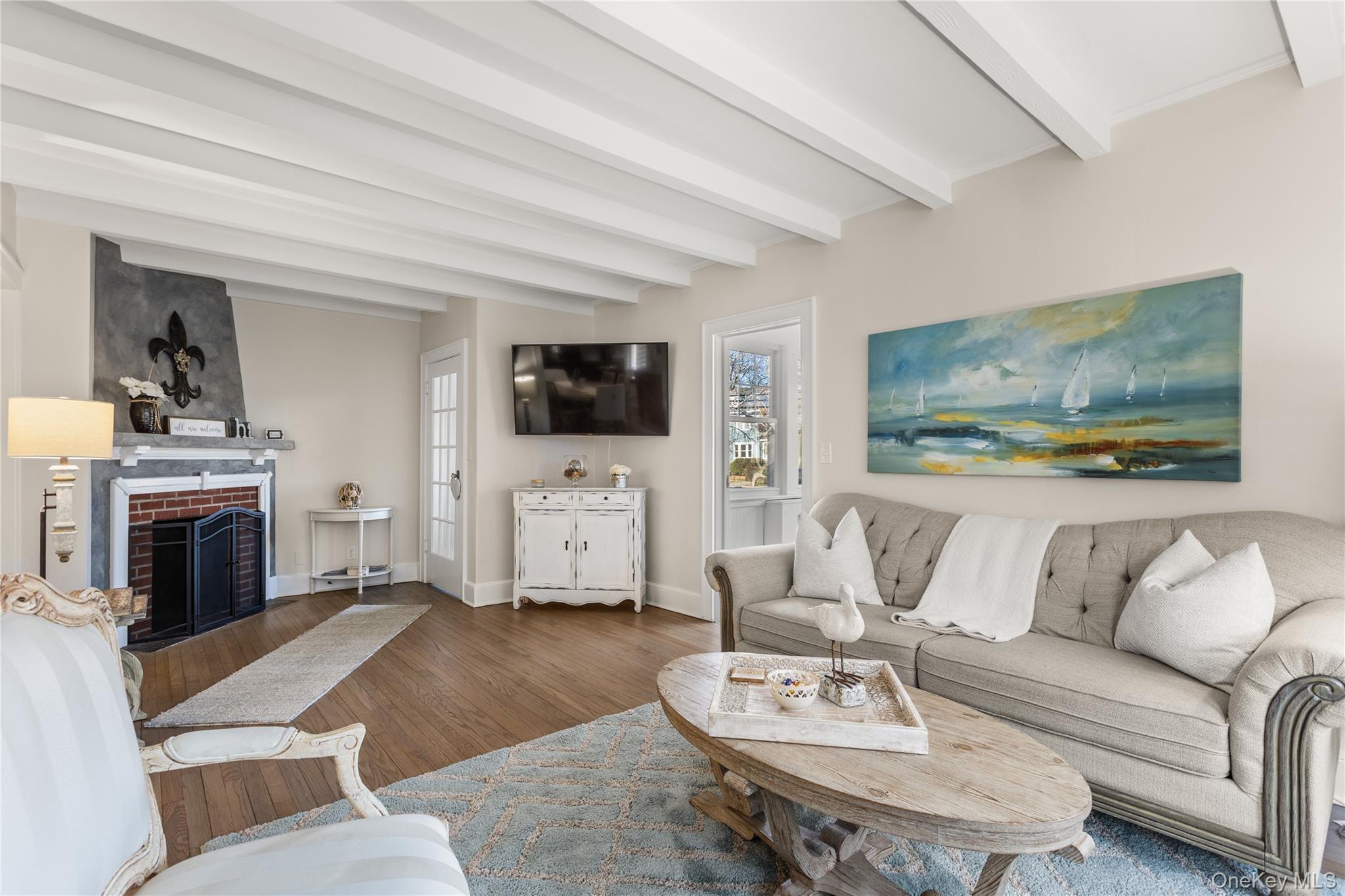 26 Community Road Bay Shore, NY 11706 - Photo 2 of 27 a living room with furniture and a fireplace