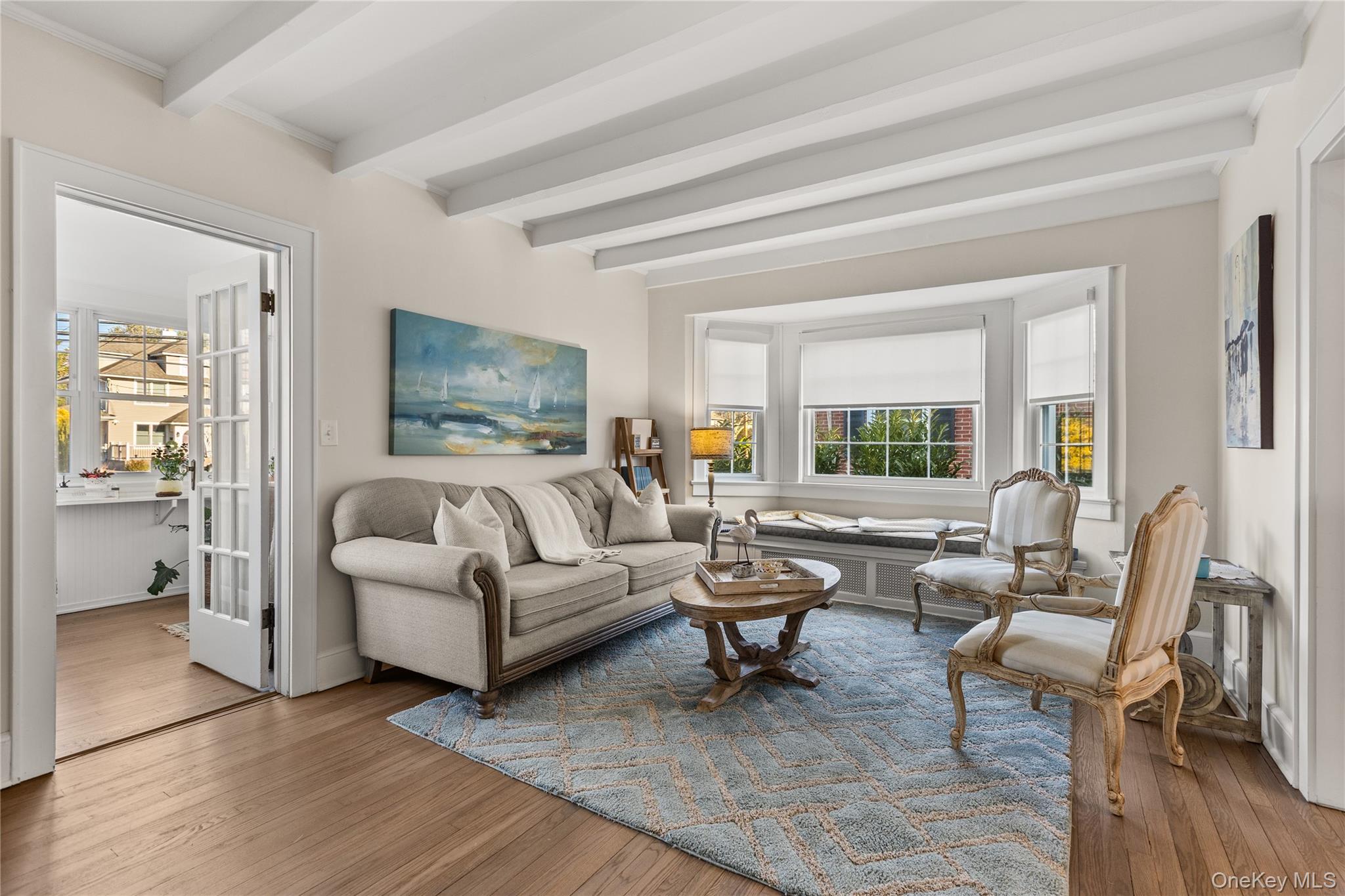 26 Community Road Bay Shore, NY 11706 - Photo 4 of 27 a living room with furniture and a potted plant on table