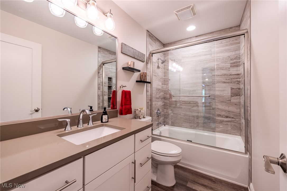 6268 Summers Road Windsor, OH 44099 - Photo 35 of 49 Ensuite bath with toilet, wood finished floors, vanity, and enclosed tub / shower combo