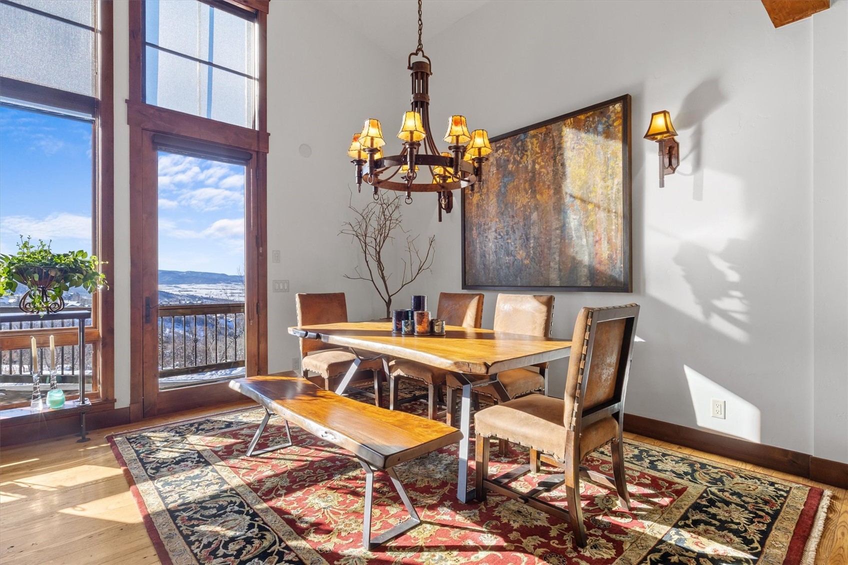 2324 Glacier Ridge, Unit B Steamboat Springs, CO 80487 - Photo 13 of 46 Dining area with healthy amount of natural light, wood finished floors, a chandelier, and high vaulted ceiling