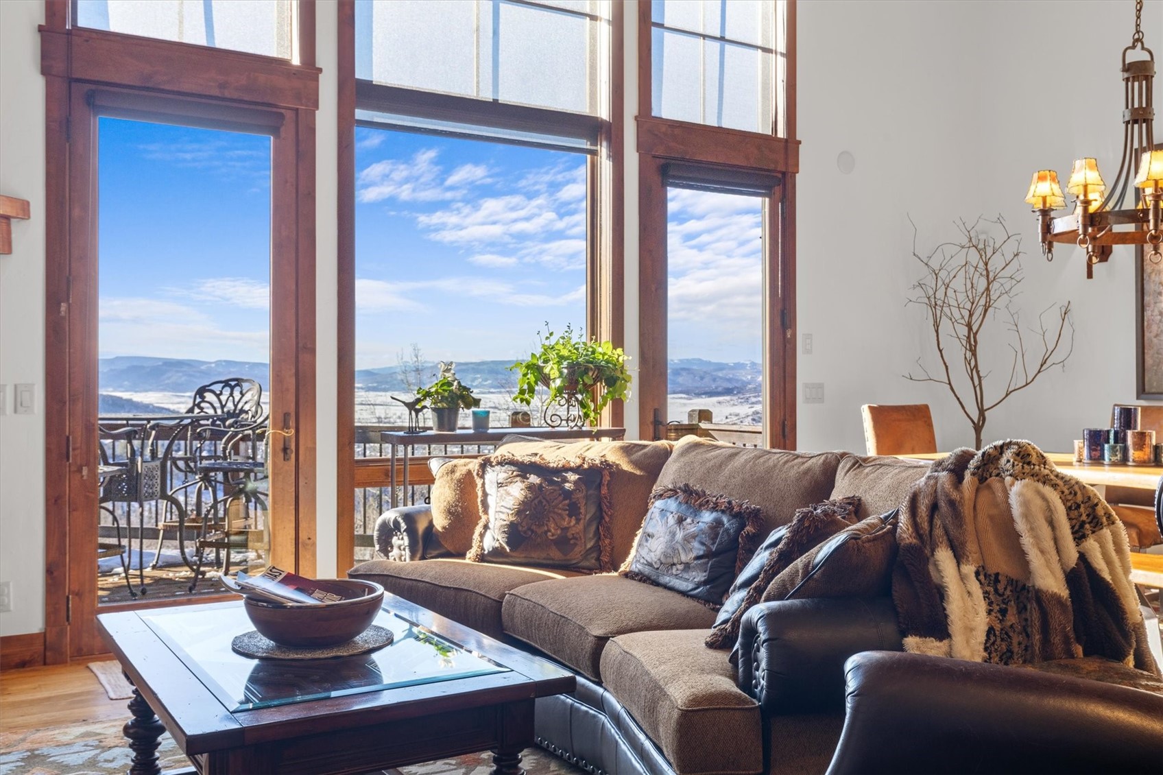 2324 Glacier Ridge, Unit B Steamboat Springs, CO 80487 - Photo 15 of 46 Living area with a mountain view, a chandelier, and wood finished floors