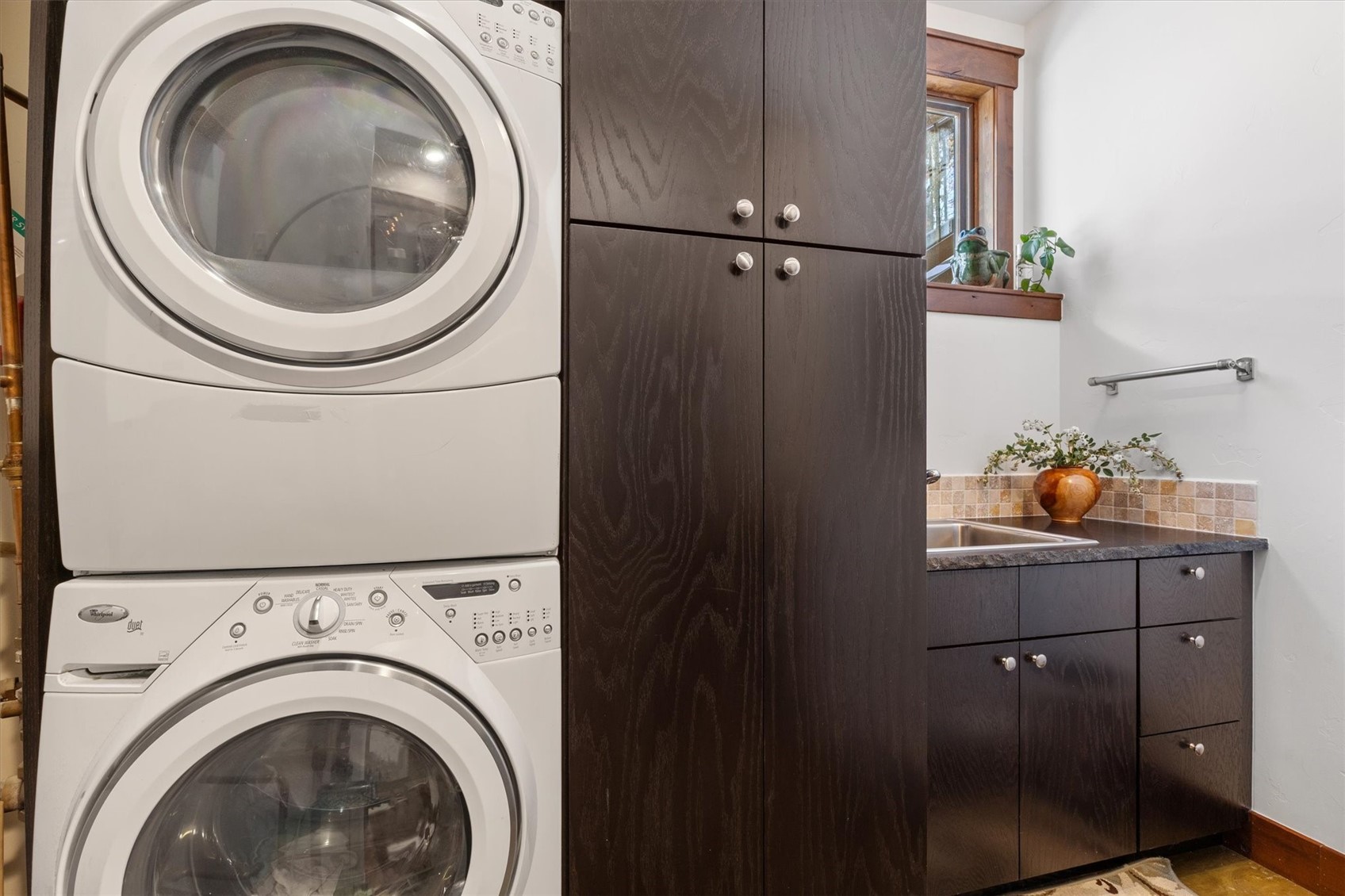 2324 Glacier Ridge, Unit B Steamboat Springs, CO 80487 - Photo 24 of 46 Washroom featuring cabinet space and stacked washer / drying machine
