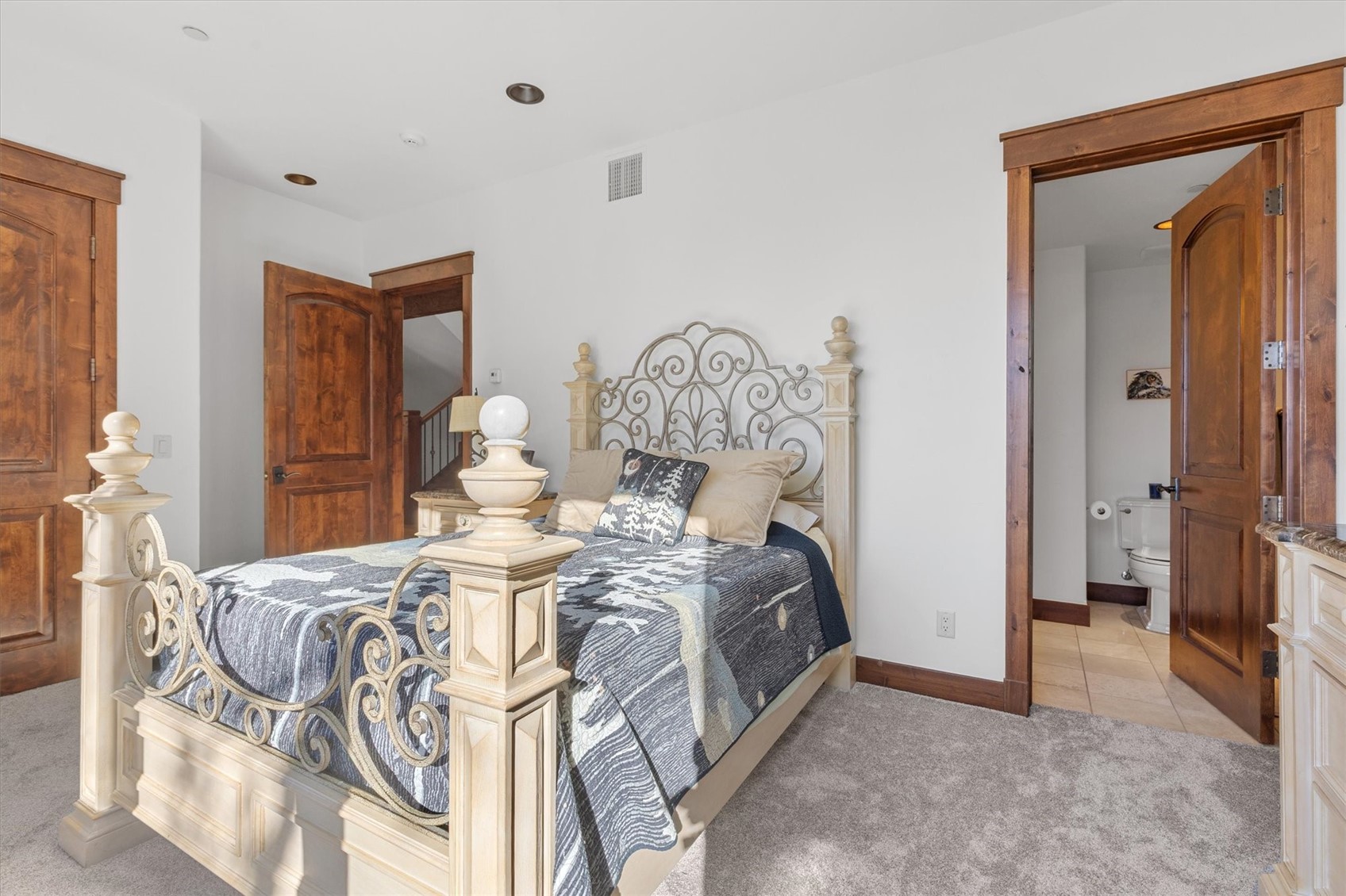 2324 Glacier Ridge, Unit B Steamboat Springs, CO 80487 - Photo 27 of 46 Bedroom with light carpet and ensuite bath