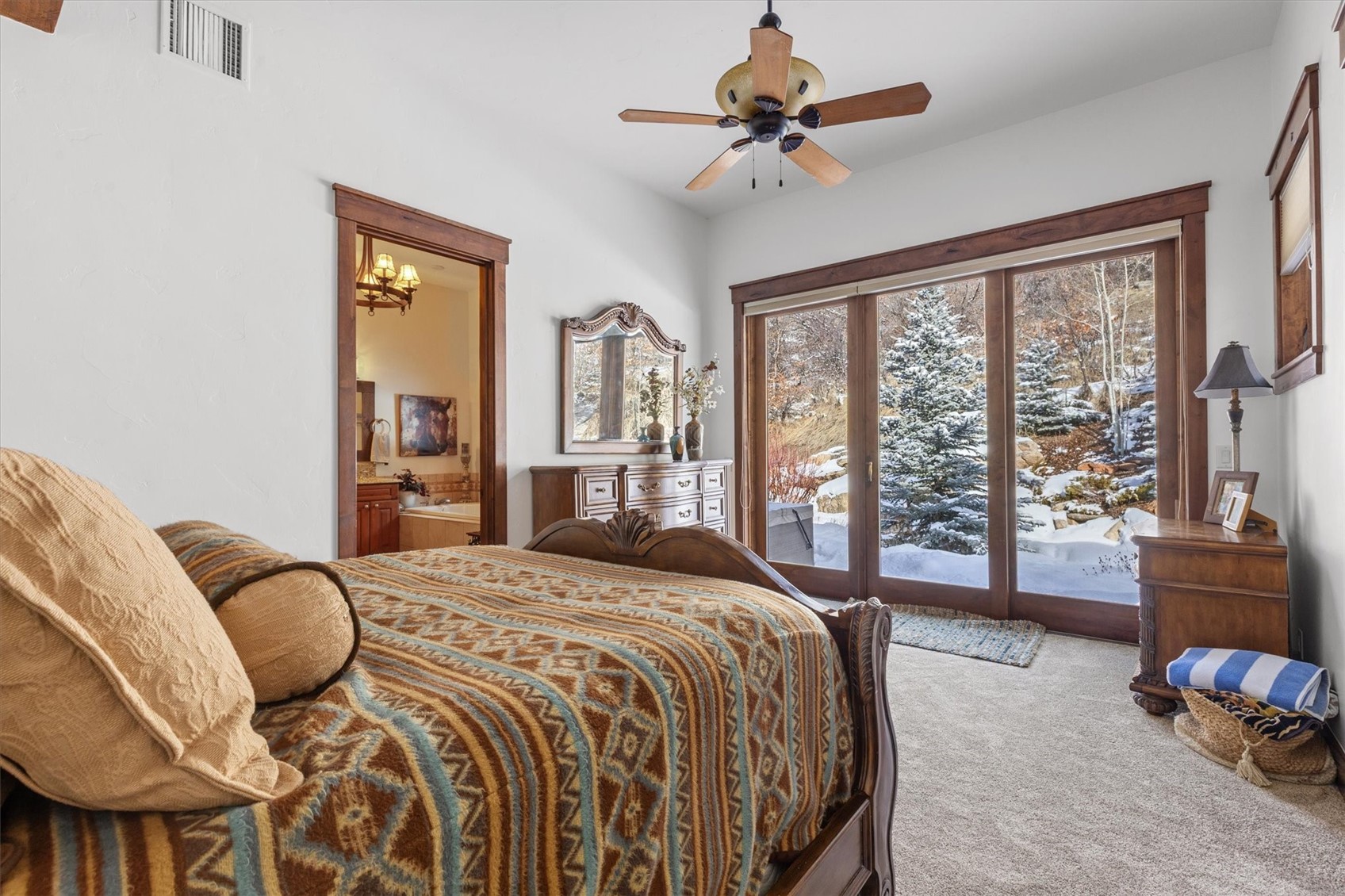 2324 Glacier Ridge, Unit B Steamboat Springs, CO 80487 - Photo 31 of 46 Carpeted bedroom featuring access to outside, ensuite bathroom, and a ceiling fan