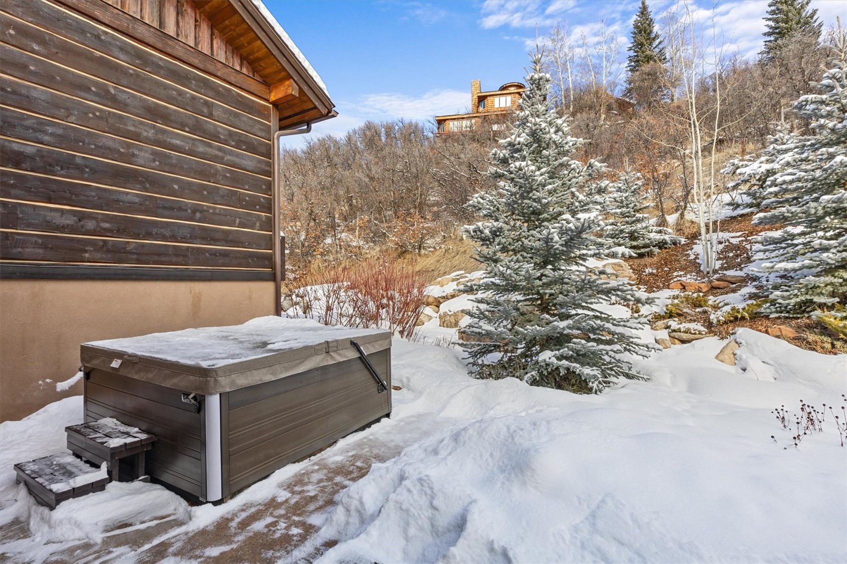 2324 Glacier Ridge, Unit B Steamboat Springs, CO 80487 - Photo 34 of 46 Yard covered in snow with a hot tub