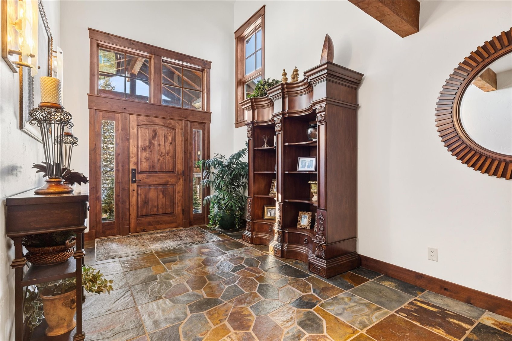 2324 Glacier Ridge, Unit B Steamboat Springs, CO 80487 - Photo 4 of 46 Entrance foyer featuring stone tile flooring, a high ceiling, and healthy amount of natural light