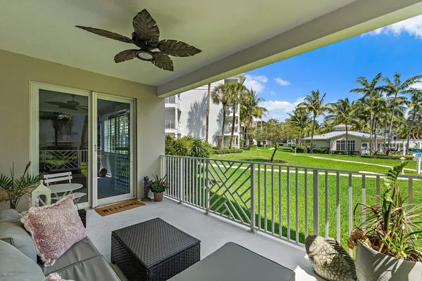 a view of a porch with furniture and a yard
