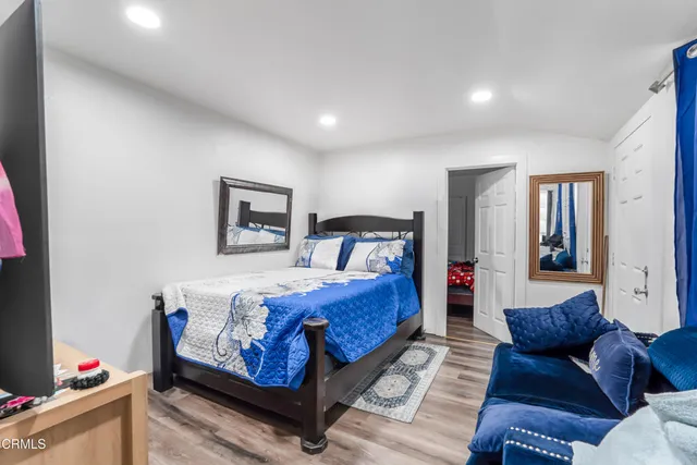 a bedroom with a bed and a couch