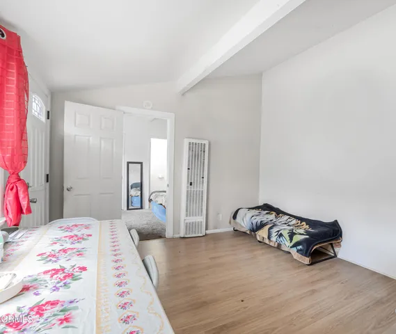 a bedroom with a bed and a dresser