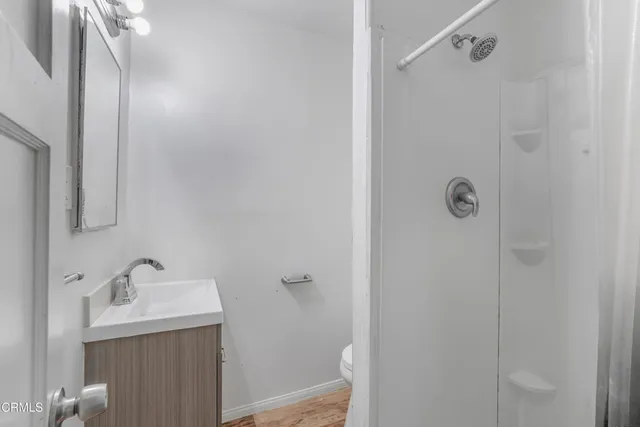 a bathroom with a sink a mirror and shower