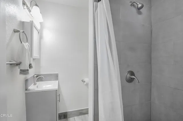 a bathroom with a sink a mirror and shower