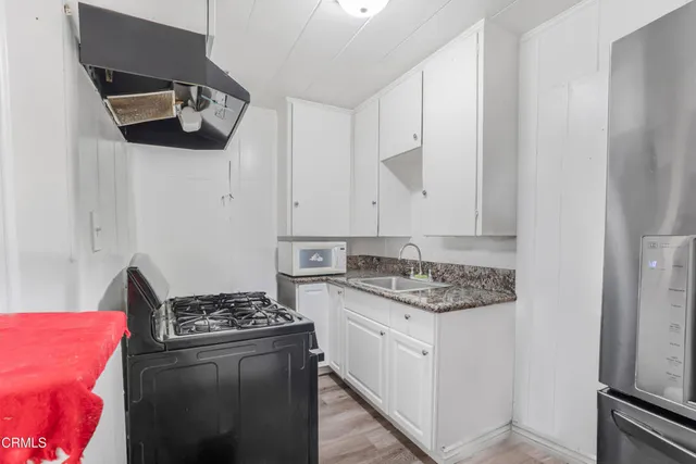 a kitchen with stainless steel appliances granite countertop a stove and a sink