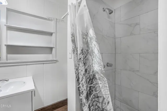 a bathroom with a shower curtain and a sink