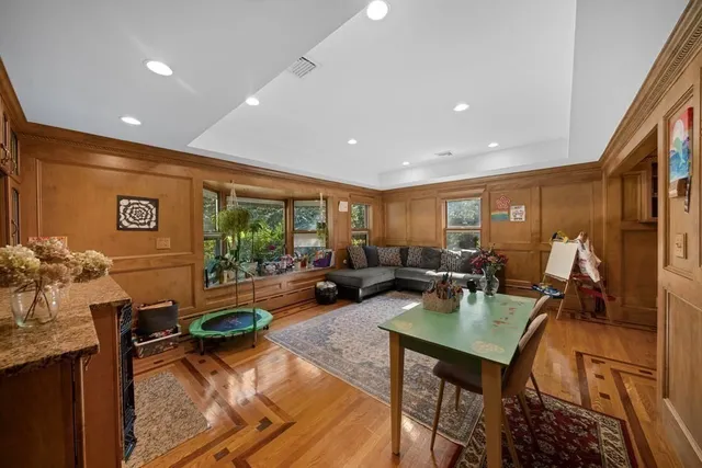 a living room with furniture a rug and a window