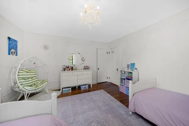 a bedroom with a bed and a chandelier