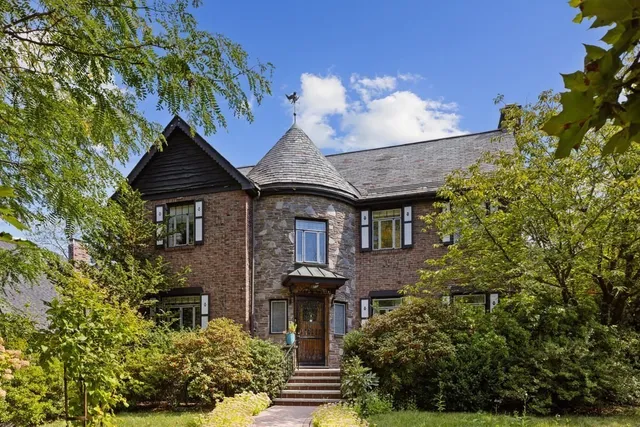 front view of a house with a fountain
