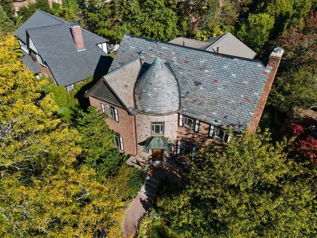 an aerial view of a house with a yard and garden
