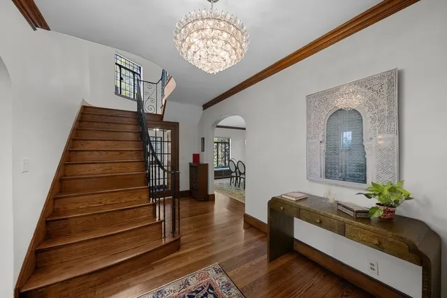a living room with furniture and a chandelier