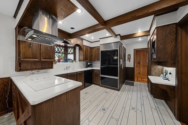 a kitchen with a sink and wooden floor