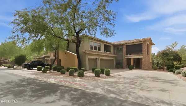 a front view of a building with a garden