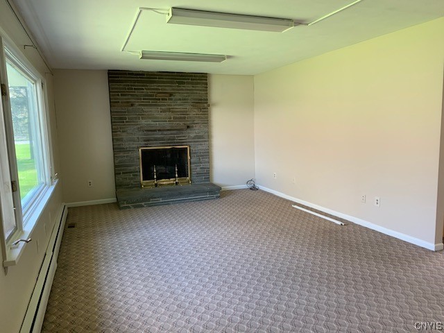 245 East Main Street Elbridge, NY 13060 - Photo 10 of 22 Living Room with picture window to the wooded yard