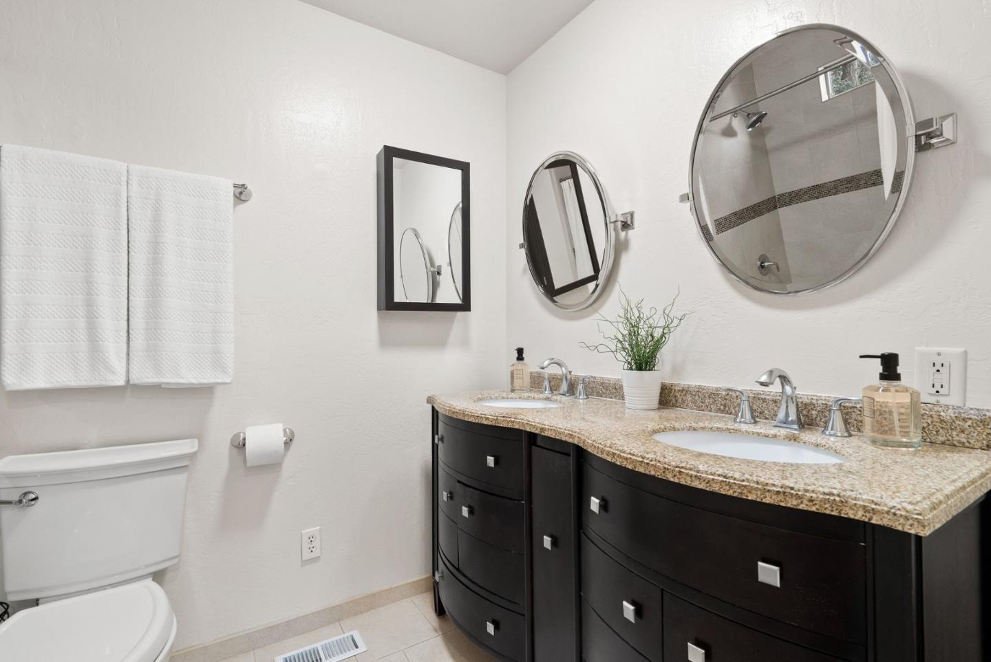 600 Cook Way Ben Lomond, CA 95005 - Photo 21 of 36 a bathroom with a granite countertop double vanity sink and a mirror