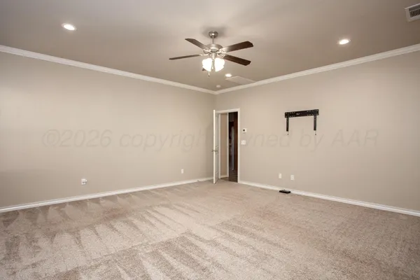 an empty room with a ceiling fan and a window