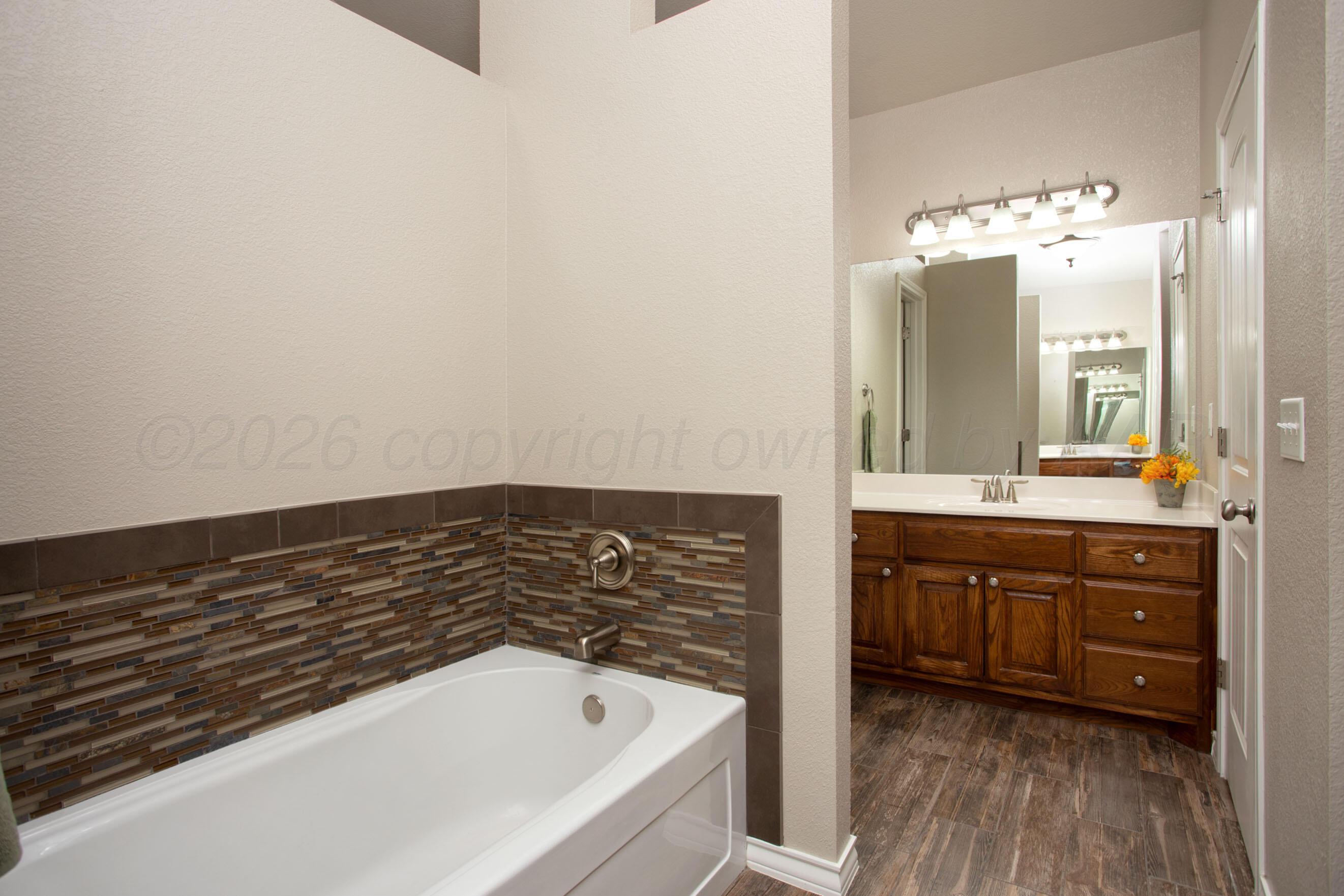 18400 Sundancer Lane Bushland, TX 79124 - Photo 18 of 58 a bathroom with a bathtub and a sink