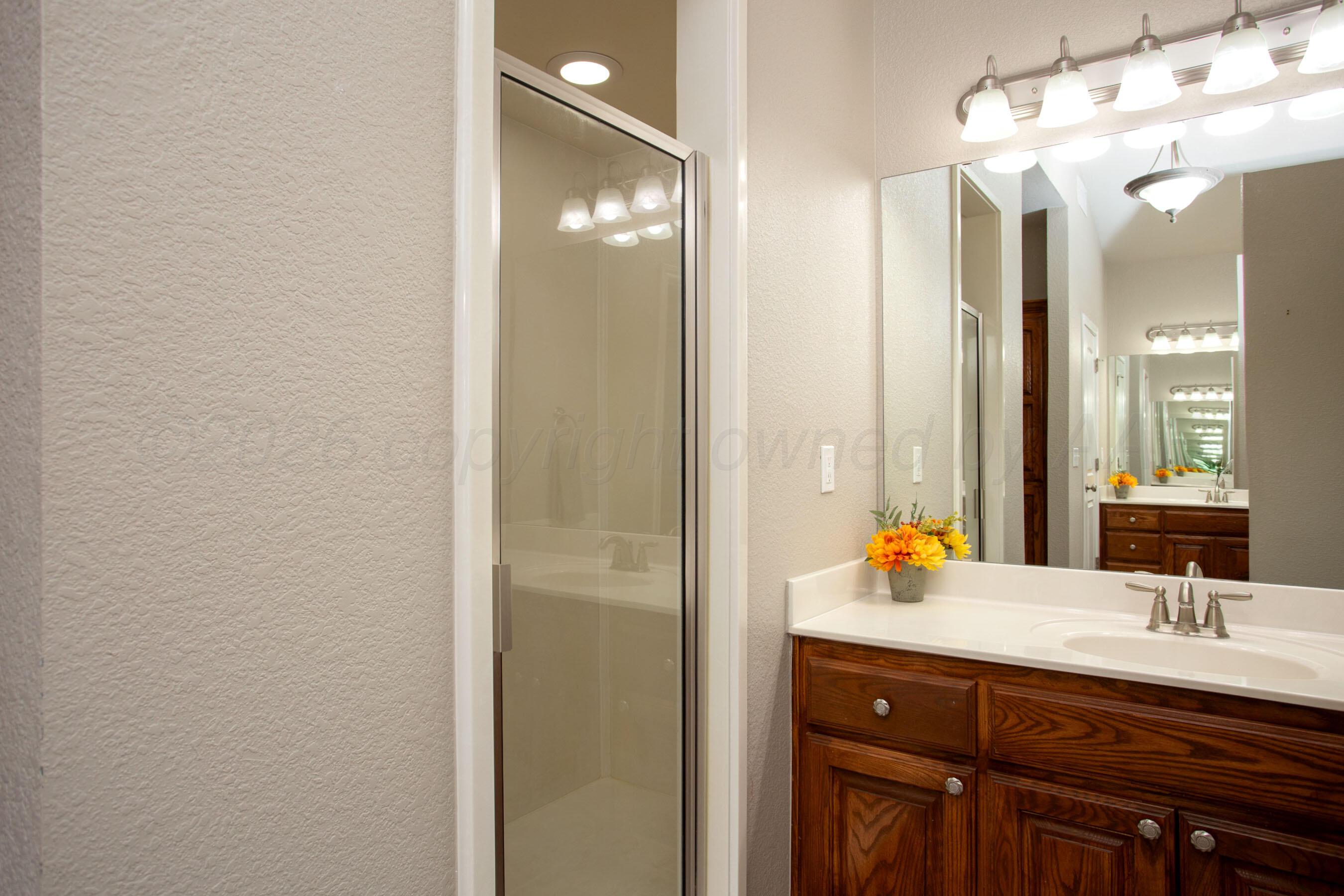 18400 Sundancer Lane Bushland, TX 79124 - Photo 19 of 58 a bathroom with a double vanity sink and a mirror