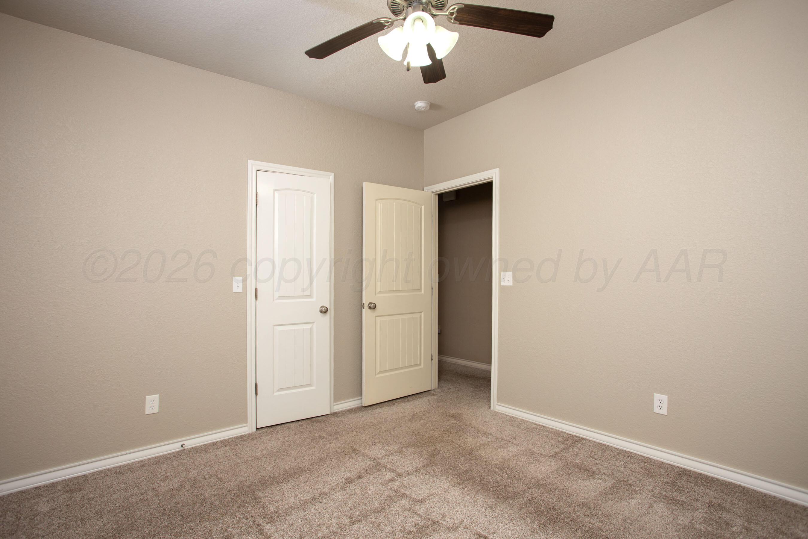 18400 Sundancer Lane Bushland, TX 79124 - Photo 32 of 58 an empty room with a chandelier fan and a ceiling fan