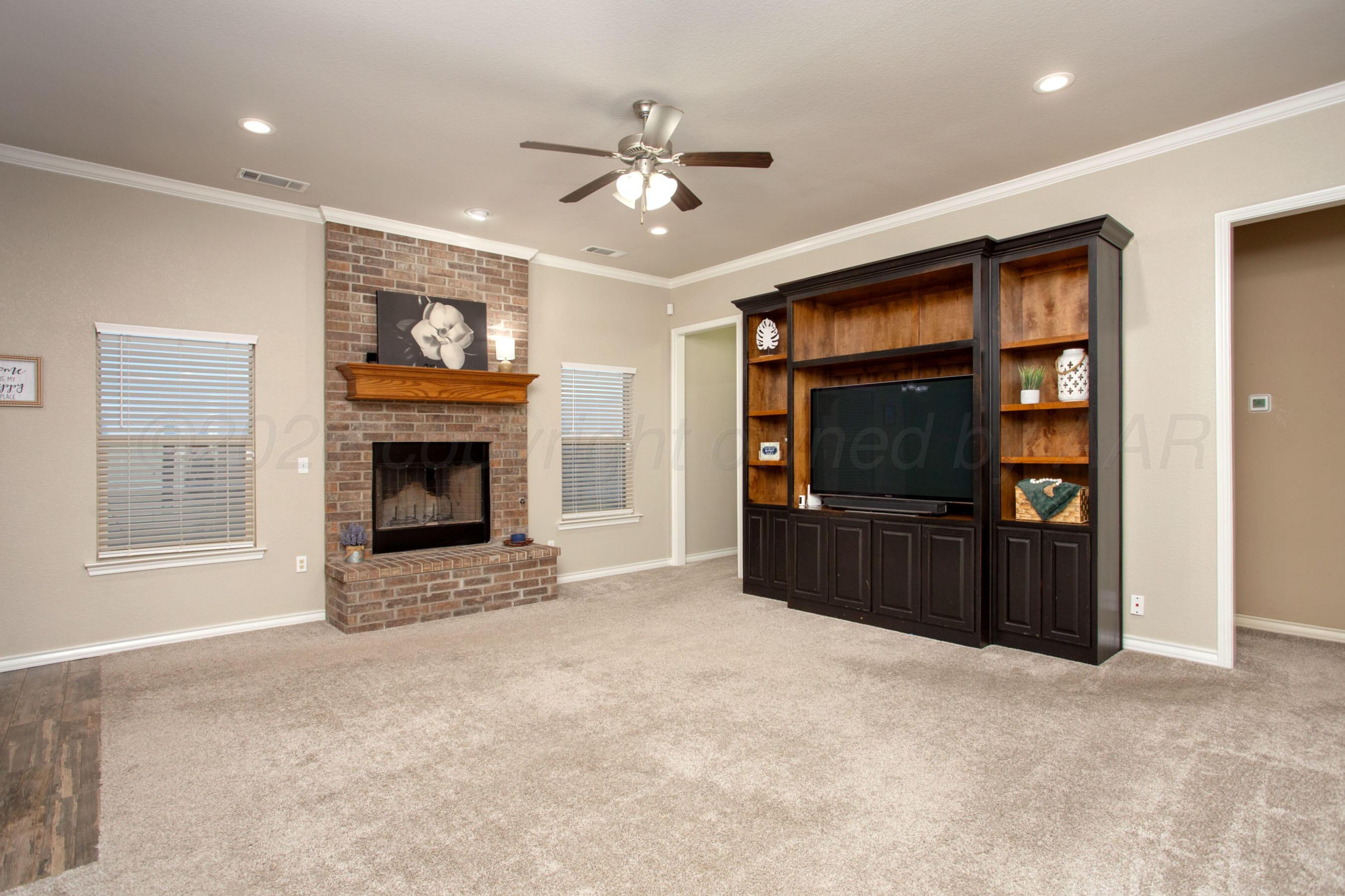 18400 Sundancer Lane Bushland, TX 79124 - Photo 5 of 58 a living room with furniture a flat screen tv and a fireplace