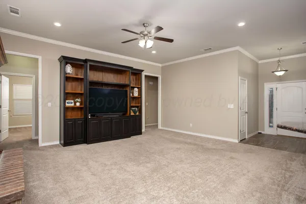 a view of a livingroom with a chandelier fan and closet