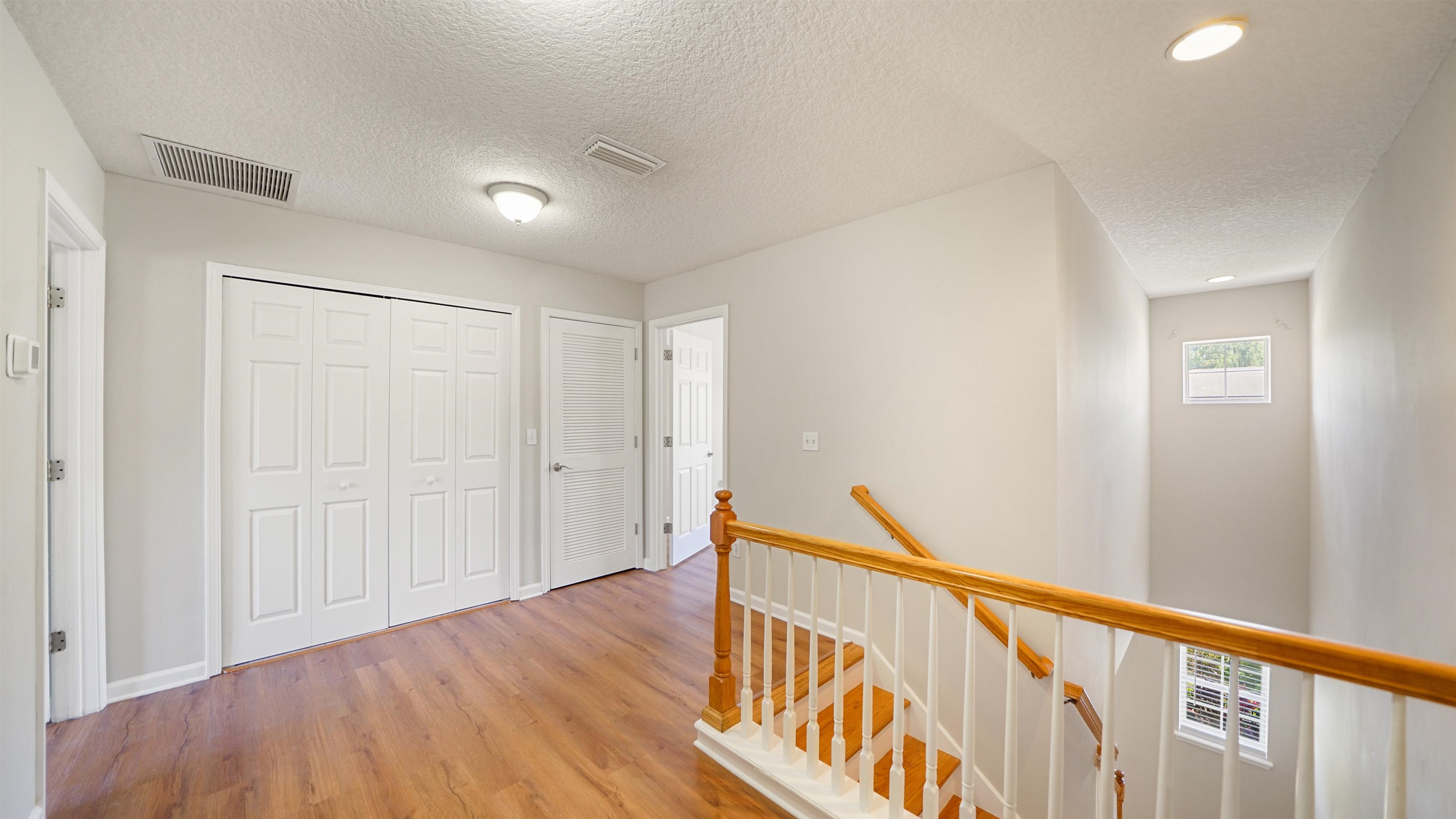 18 Amistad Drive, Unit 18 St. Augustine, FL 32086 - Photo 14 of 36 a view of a hallway with wooden floor and stairs