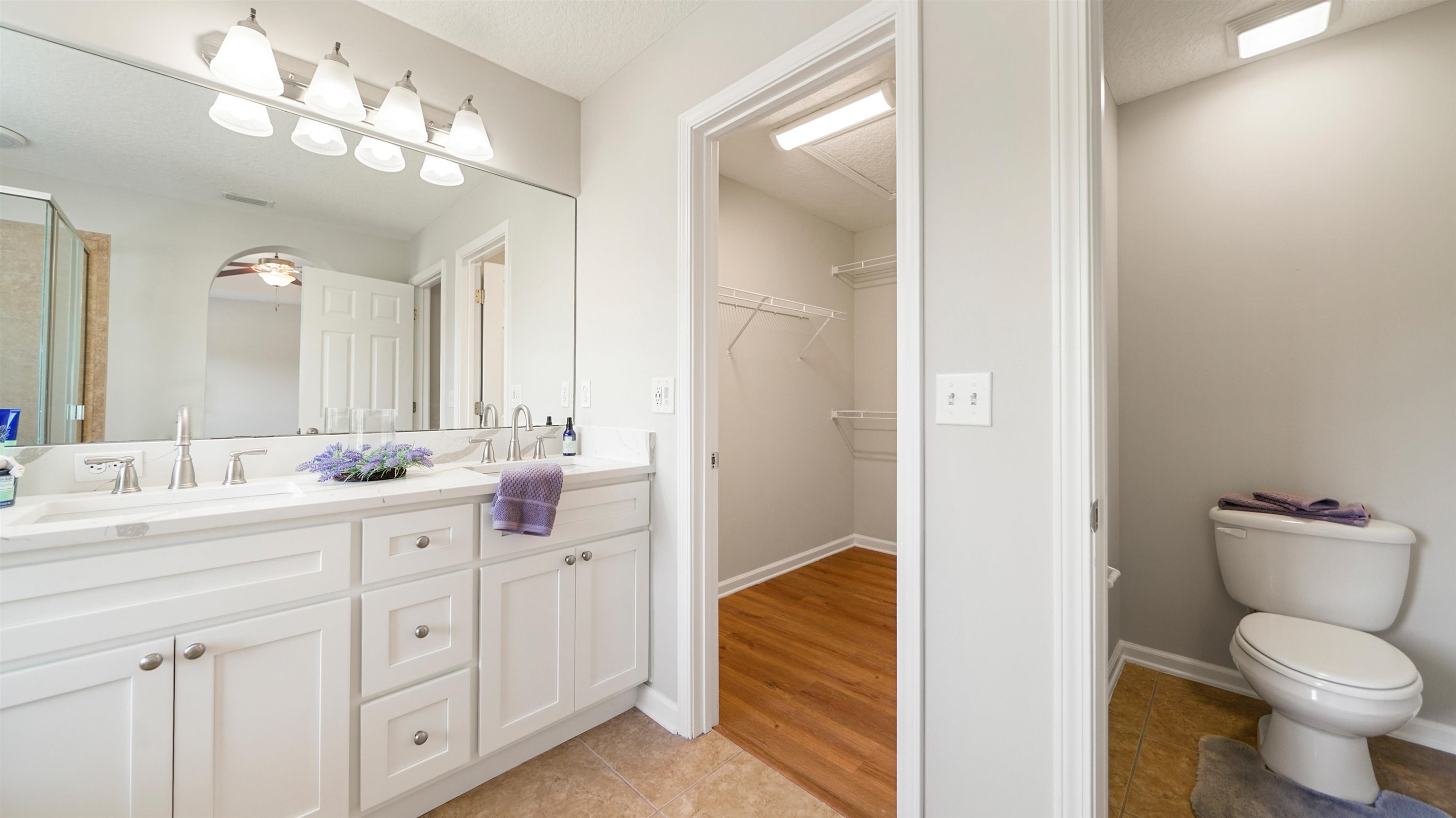 18 Amistad Drive, Unit 18 St. Augustine, FL 32086 - Photo 18 of 36 a bathroom with a sink a toilet and a large mirror